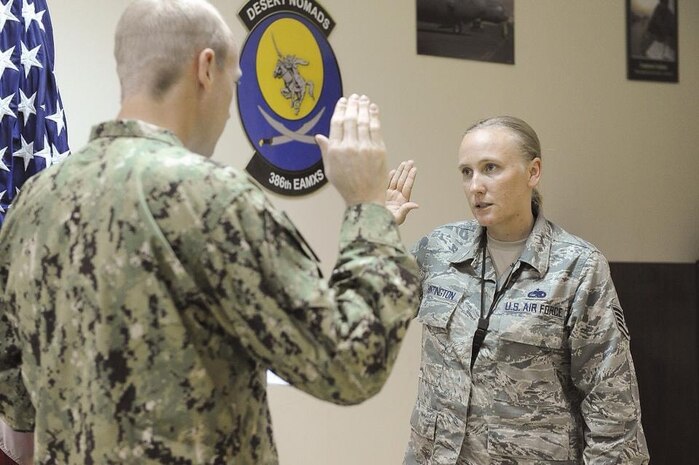 U.S. Air Force Staff Sgt. Natalie Huntington, 386th Expeditionary Maintenance Squadron munitions specialist, is re-enlisted by U.S. Coast Guard Chief Warrant Officer 2 Chris Huntington, Coast Guard Investigative Services, at Ali Al Salem Air Base, Kuwait in 2013.