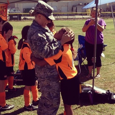 U.S. Air Force Staff Sgt. Natalie Huntington surprises her daughter after returning home from a deployment in Kuwait in 2013.