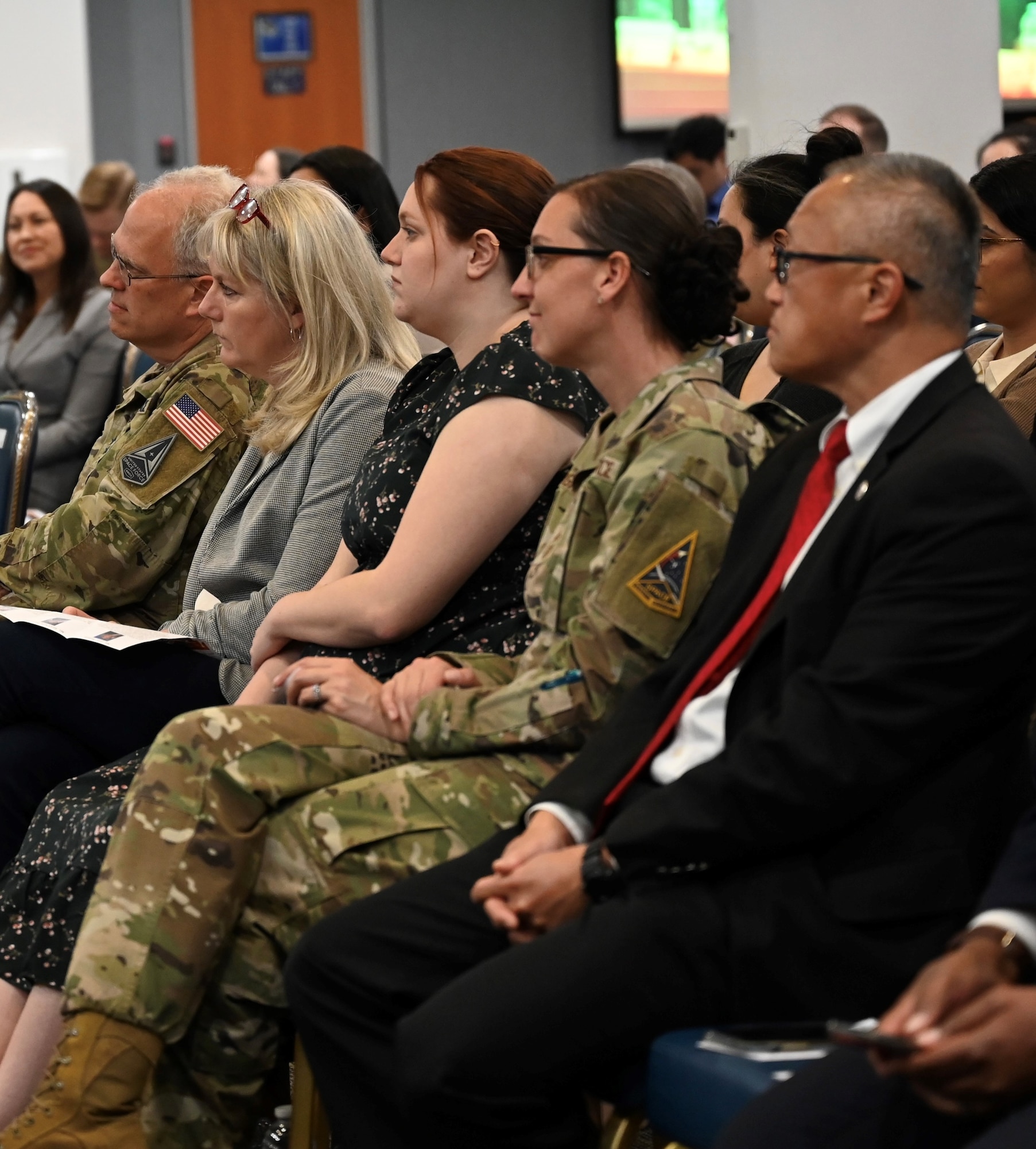 Front row at Los Angeles Air Force Base’s Women In Leadership Panel sitting in the audience pictured left to right is Lieutenant General Philip Garrant, spouse Heather Garrant and their daughter as well as Chief Master Sergeant Sarah R. L. Morgan, and Mayor George Chen.