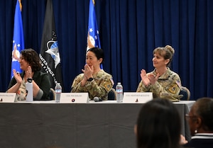 Left to right in the photo Ms. Shannon Pallone, Colonel Mia L. Walsh, and Colonel Heather B. Bogstie seated at table participating in a round of applause as the Los Angeles Air Force Base’s 2024 Women In Leadership Panel ended.