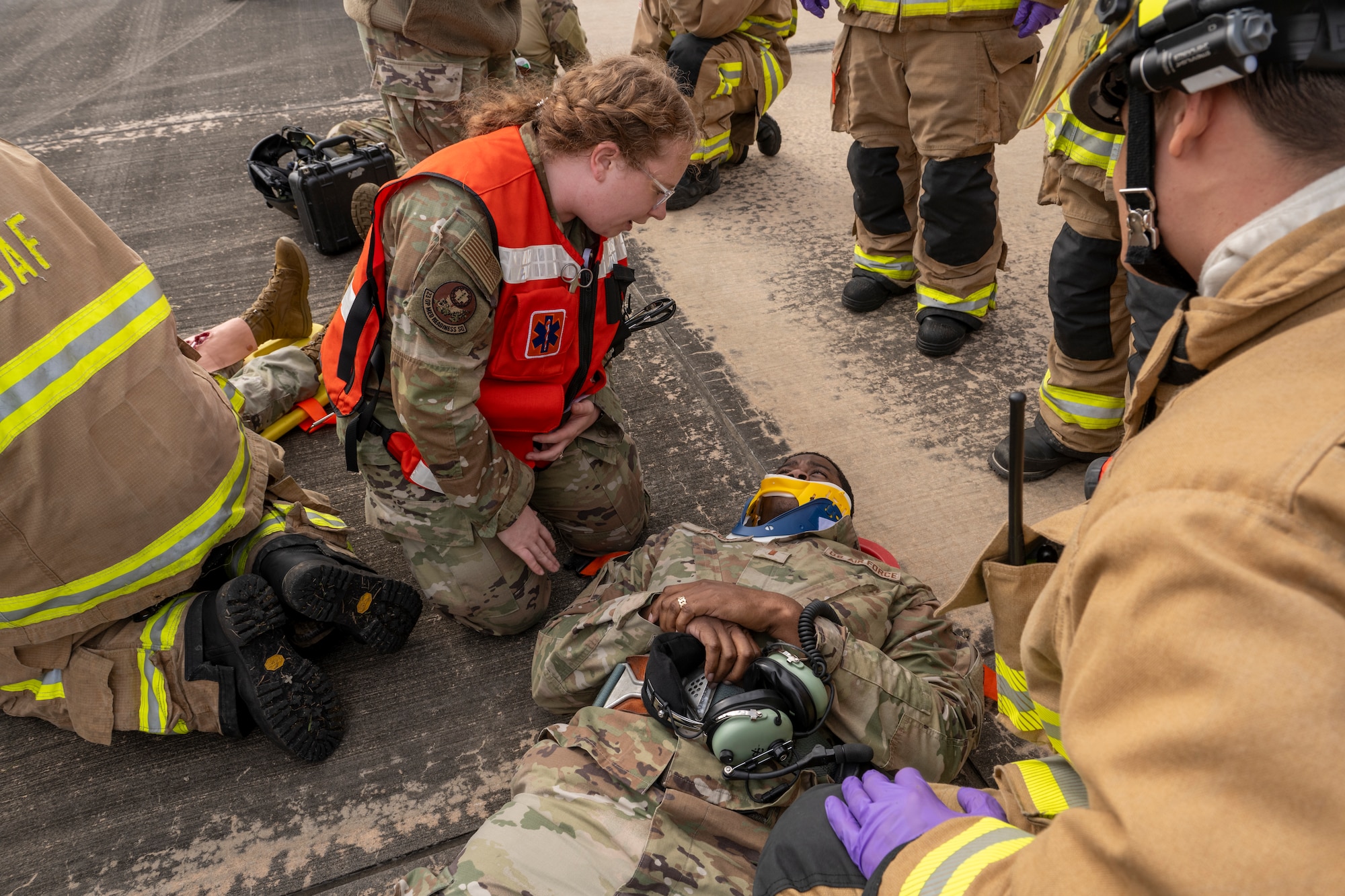 U.S. Air Force Staff Sgt. Allison Gibree, 23rd Medical Group Flight and Operational Medicine Clinic noncommissioned officer in charge, assesses a simulated patient during an aircraft accident response exercise at Moody Air Force Base, Georgia, March 26, 2024. This home-station exercise simulated a hard landing of an HH-60W Jolly Green II, resulting in injured aircrew members. The scenario tested the communication and response of Moody AFB Airmen from various organizations across the 23rd Wing. (U.S. Air Force photo by Senior Airman Deanna Muir)