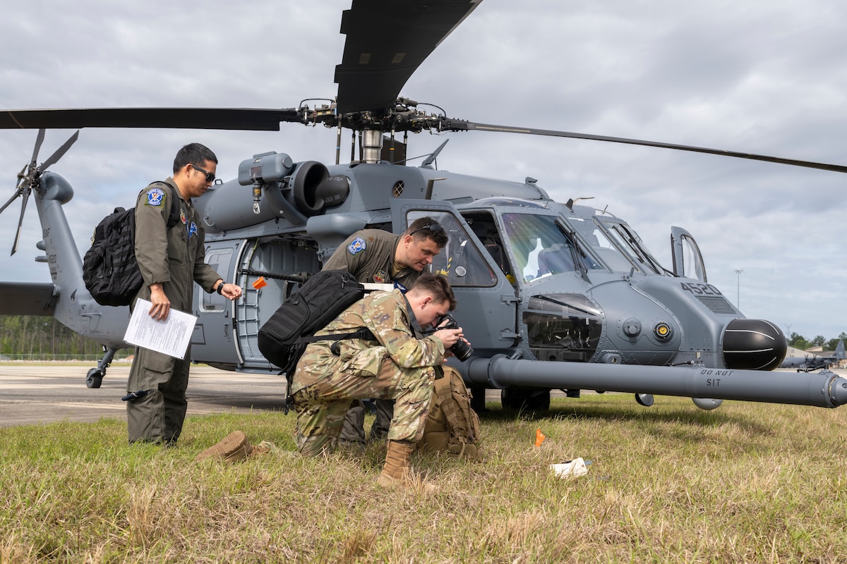 U.S. Air Force Airman Cade Ellis, 23rd Wing Public Affairs apprentice, takes a photo of evidence during an aircraft accident response exercise at Moody Air Force Base, Georgia, March 26, 2024. Public Affairs and the 23rd Wing Safety collected, protected, and preserved evidence from the simulated hard landing. (U.S. Air Force photo by Senior Airman Deanna Muir)
