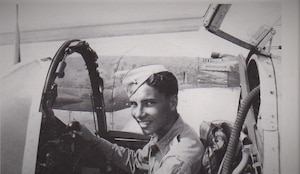 James Stark sits in a P-38, the plane he flew during WWII.