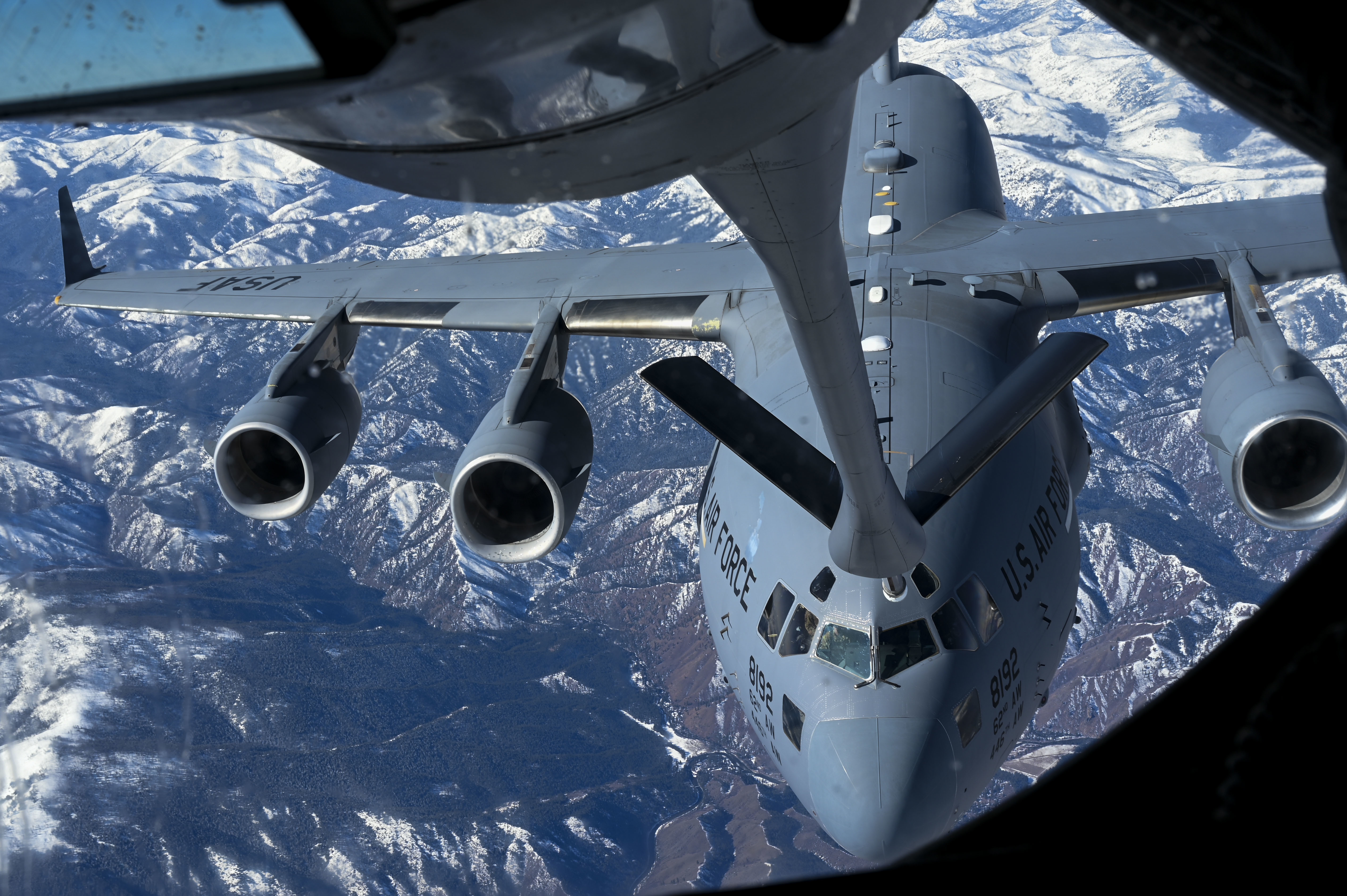 A C-17 flies towards KC-135