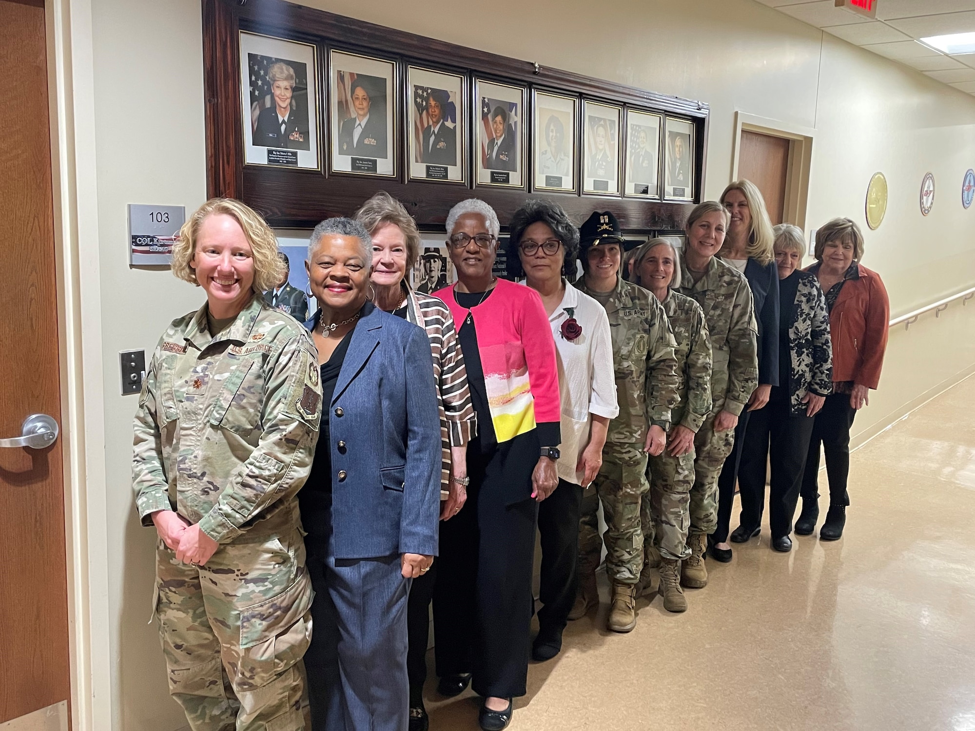 Current and former members of the Tennessee National Guard featured on the new Women’s History Wall pose in front of the memorial March 28, 2024, following a ribbon-cutting ceremony at Joint Force Headquarters in Nashville. The wall features 23 women who were the first in their respective positions, such as the first female Black Hawk pilot and the first female general officer, of the Tennessee National Guard.