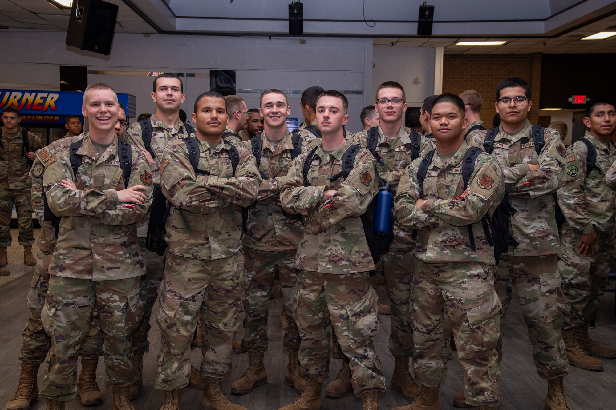 Airmen stand in a group during a function