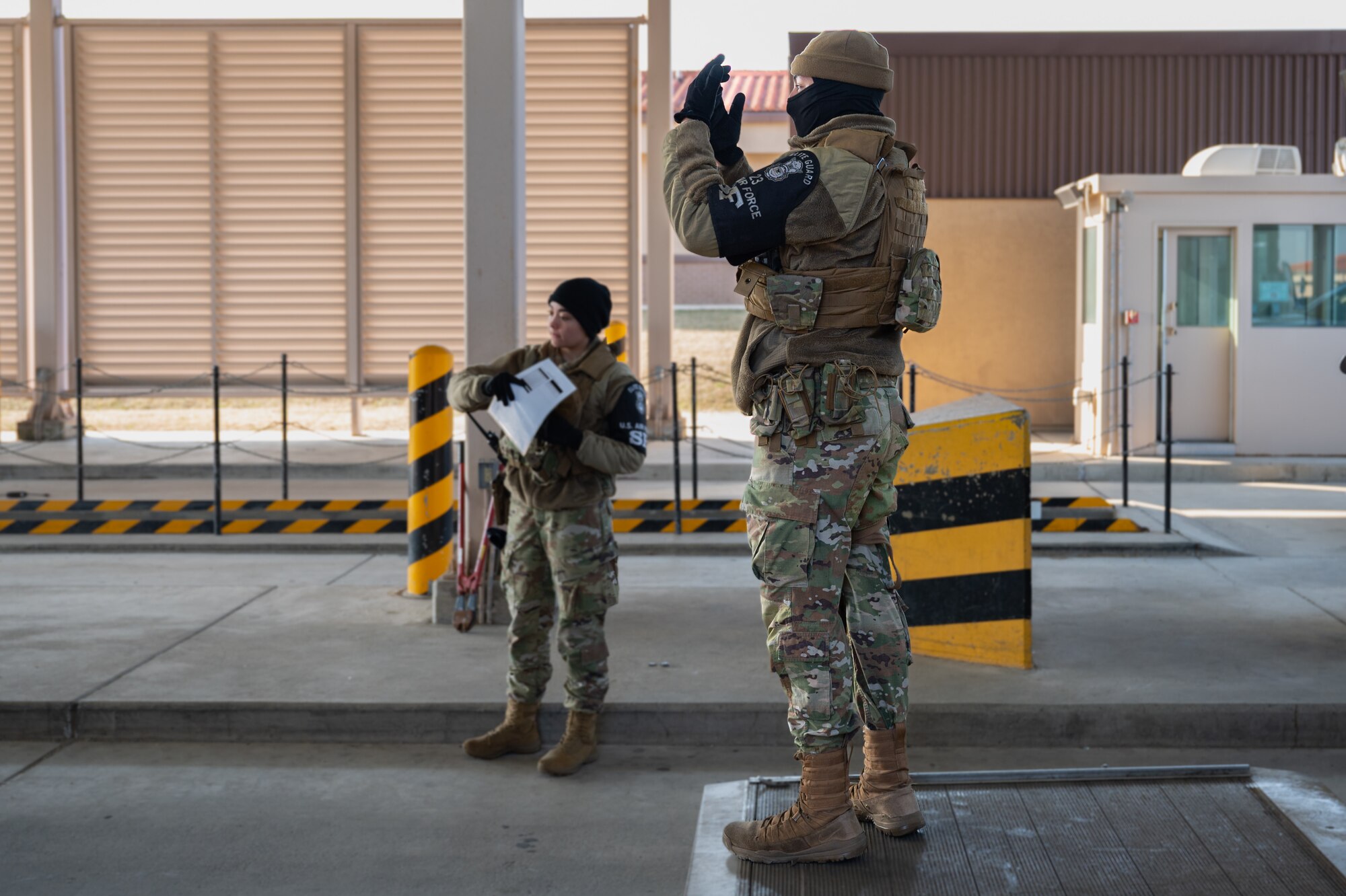 U.S. Air Force Airman 1st Class Giana Couch, left, and Airman 1st Class Vincent Orlandini, 51st Security Forces Squadron elite guards, direct traffic at Osan Air Base, Republic of Korea, March 21, 2024. Elite guards undergo specialized training in base defense and installation access and control, equipping them with the expertise needed to ensure the safeguarding of Osan AB and the ROK. (U.S. Air Force photo by Senior Airman Brittany Russell)