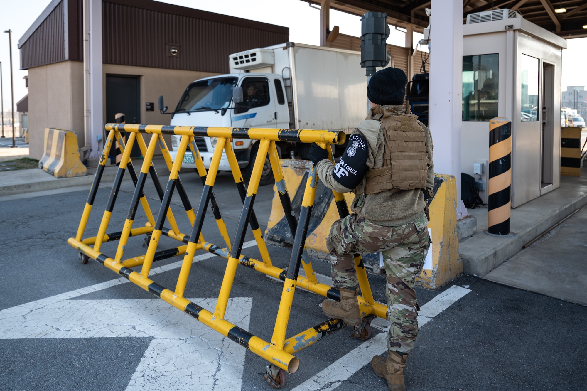 U.S. Air Force Airman 1st Class Giana Couch, 51st Security Forces elite guard, moves a barricade at Osan Air Base, Republic of Korea, March 21, 2024. The barricade was in place as elite gate guards conducted vehicle inspections to ensure that no prohibited items entered the installation. Elite guards play a pivotal role at Osan AB, safeguarding installation access and ensuring mission readiness.. (U.S. Air Force photo by Senior Airman Brittany Russell)