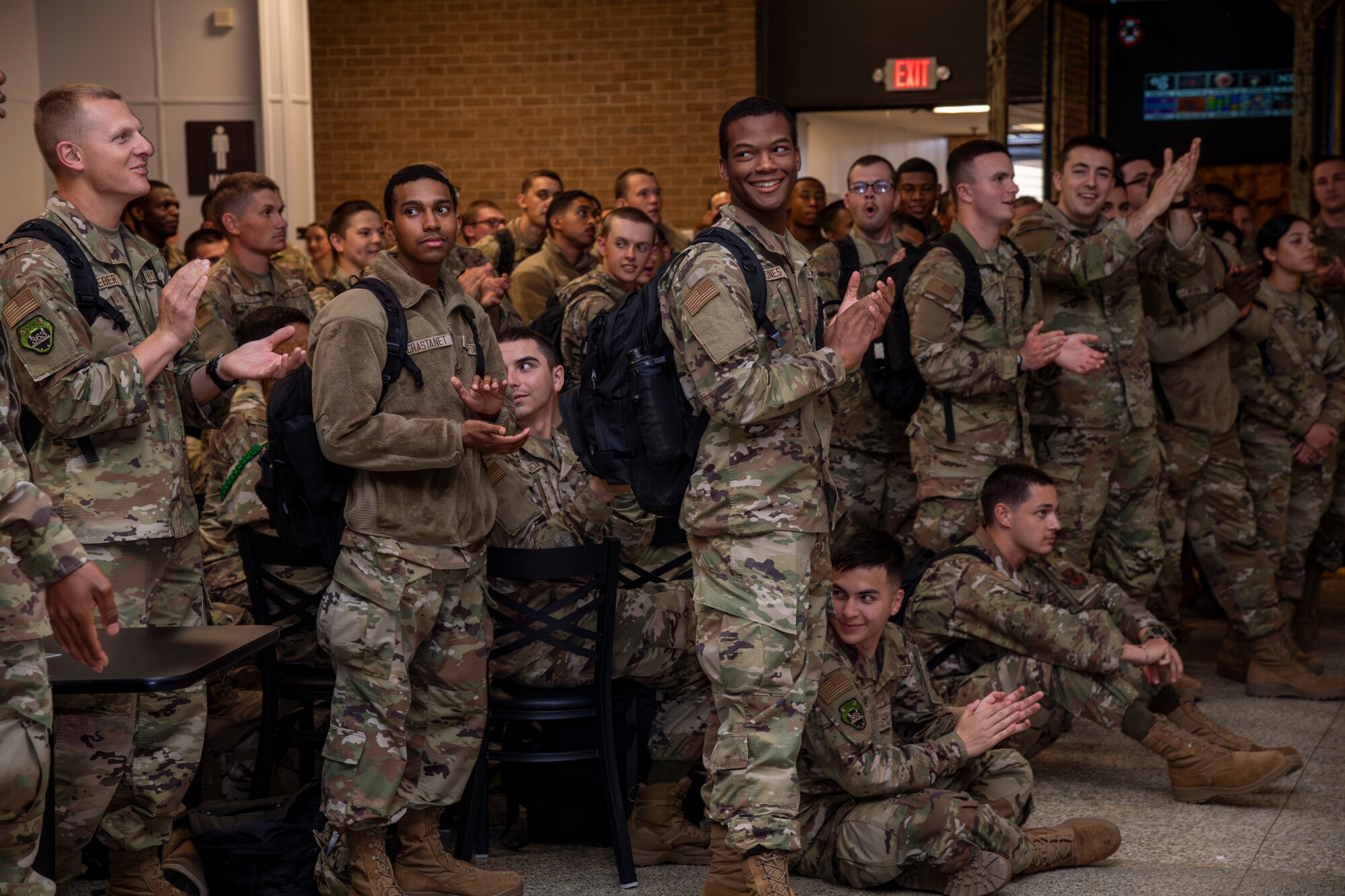 Airmen stand in a group during a function