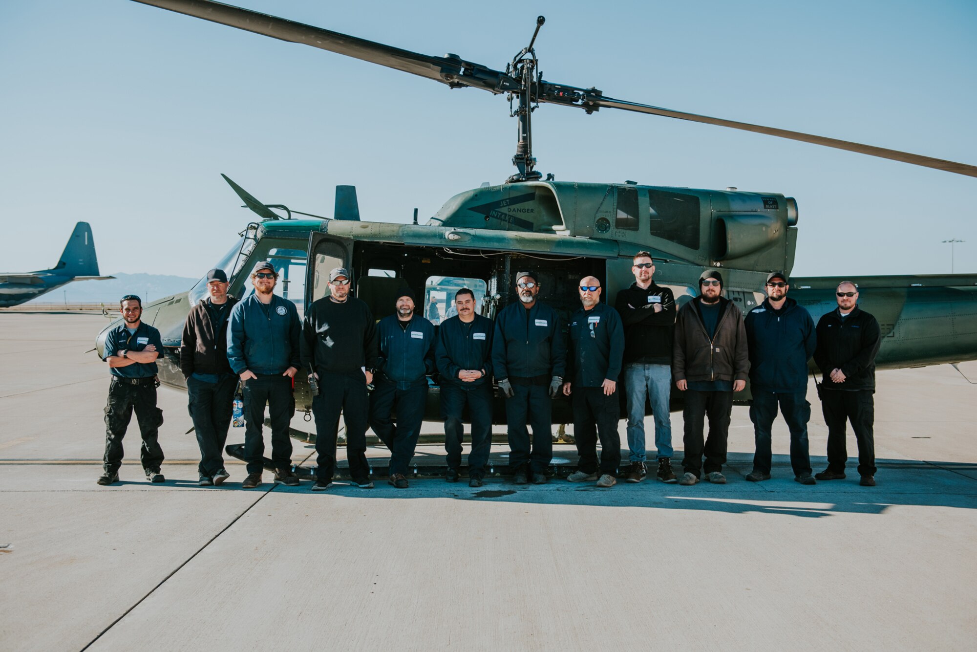 Members from the 58th Special Operations Wing pose in front of a UH-1N helicopter