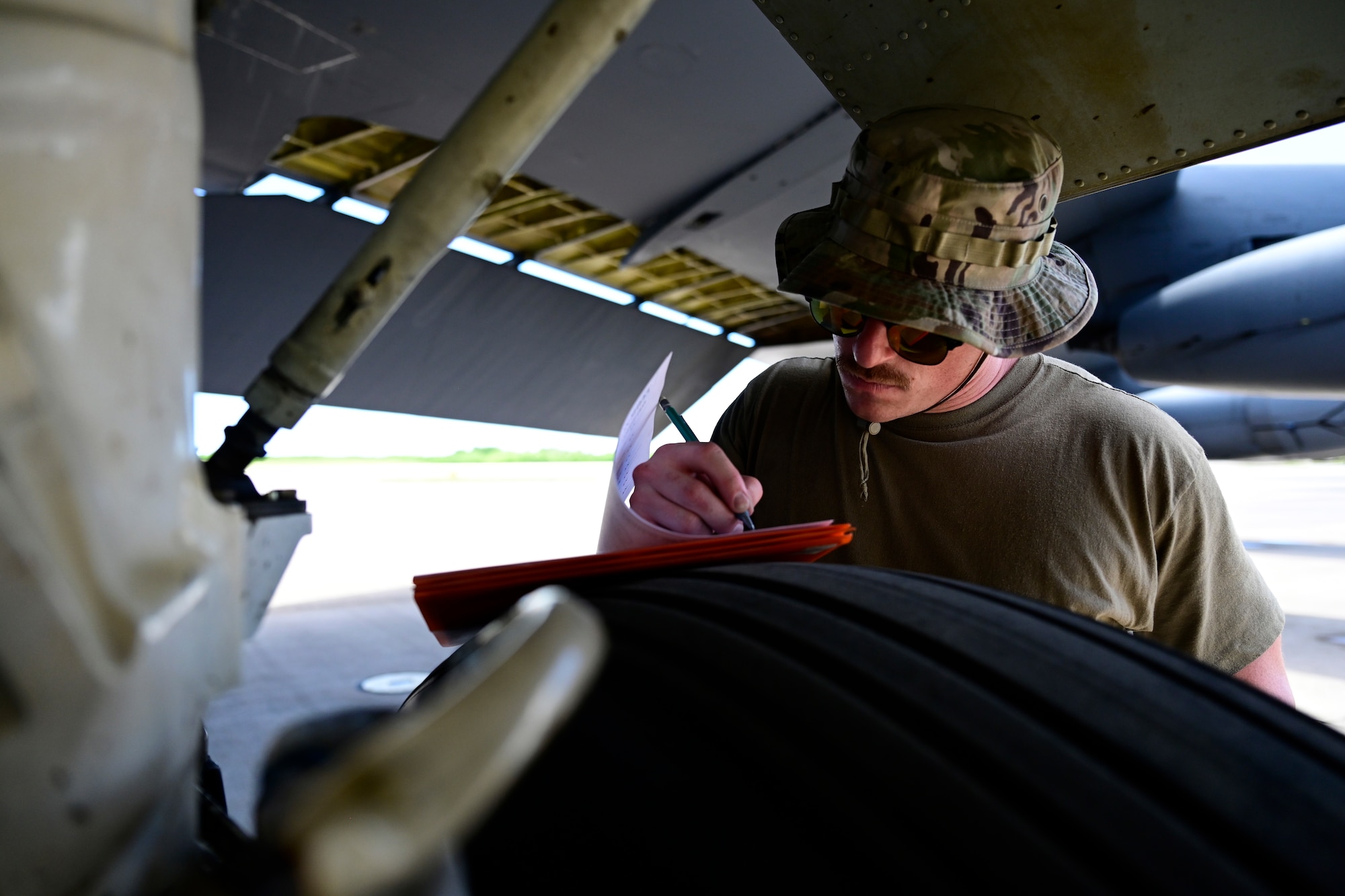 Staff Sgt. David Batchelor, 96th Aircraft Maintenance Squadron crew chief, inspects a B-52 Stratofortress assigned to Barksdale Air Force Base, Louisiana, at Navy Support Facility, Diego Garcia in support of a Bomber Task Force mission, March 23, 2024. BTF missions enable crews to maintain a high state of readiness and proficiency and validate our always-ready global strike capability. (U.S. Air Force photo by Master Sgt. Staci Kasischke)