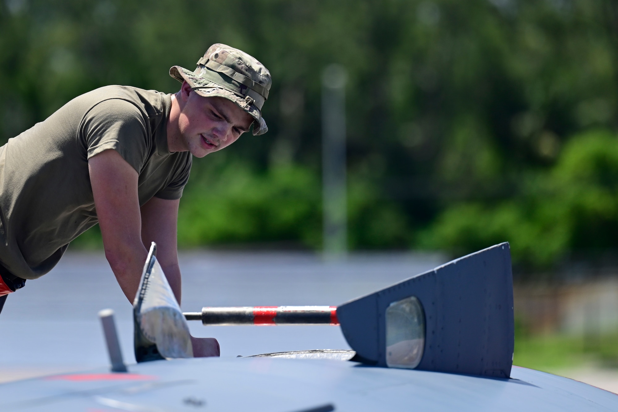 Airman 1st Class Jack Turner-Perkins, 96th Aircraft Maintenance Squadron crew chief, works on a A B-52 Stratofortress assigned to Barksdale Air Force Base, Louisiana, at Navy Support Facility, Diego Garcia in support of a Bomber Task Force mission, March 23, 2024. BTF missions enable crews to maintain a high state of readiness and proficiency and validate our always-ready global strike capability. (U.S. Air Force photo by Master Sgt. Staci Kasischke)