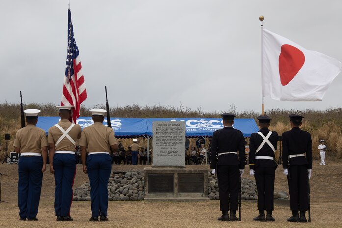 U.S. Marines with the III Marine Expeditionary Force color guard and Japan Ground Self-Defense Force color guard stand at attention during the Reunion of Honor ceremony on Iwo To, Japan, March 30, 2024. The 79th annual Reunion of Honor ceremony commemorates the veterans who fought for their respective countries on this hallowed ground; their battle has inspired future generations to value and maintain peace, security and stability in the Indo-Pacific region and beyond. (U.S. Marine Corps photo by Sgt. Christian M. Garcia)