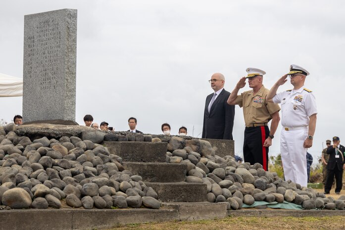 U.S. Marine Corps Lt. Gen. Roger B. Turner, center, the commanding general of III Marine Expeditionary Force, U.S. Navy Rear Adm. Carl Lahti, right, Commander, U.S. Naval Forces Japan / Commander, Navy Region Japan, and Mr. Raymond Greene, United States deputy chief of mission to Japan, salute the Reunion of Honor monument during the Reunion of Honor ceremony on Iwo To, Japan, March 30, 2024. The 79th annual Reunion of Honor ceremony commemorates the veterans who fought for their respective countries on this hallowed ground; their battle has inspired future generations to value and maintain peace, security and stability in the Indo-Pacific region and beyond. (U.S. Marine Corps photo by Sgt. Christian M. Garcia)