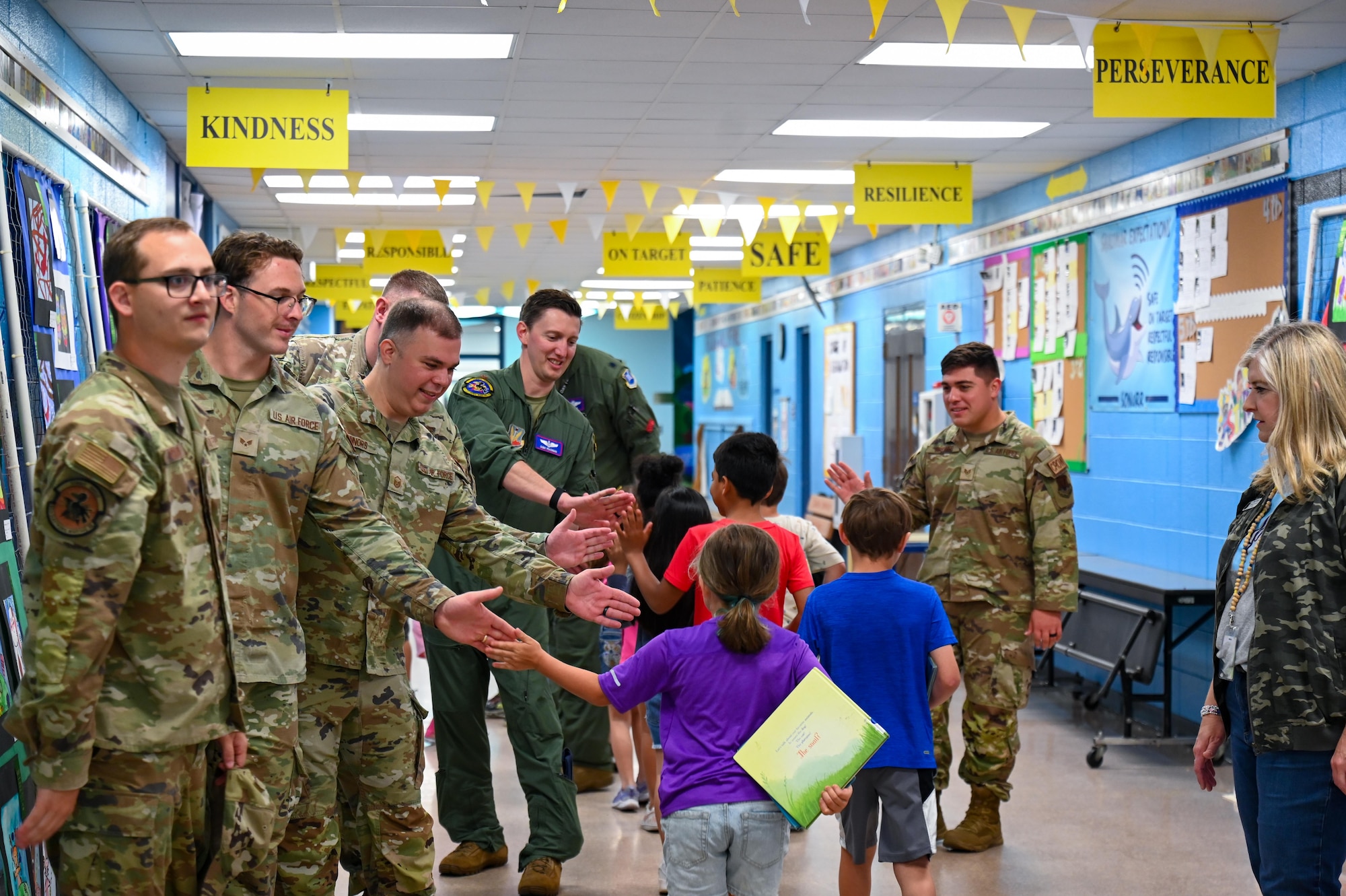 Members from the 87th Electronic Warfare Squadron participate in Military Monday by giving out high fives at Shalimar Elementary, Shalimar, Florida, April 29, 2024. Students chose high fives at the start of the school day to conclude the Month of the Military Child. (U.S. Air Force photo by Capt. Benjamin Aronson)