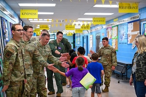 Members from the 87th Electronic Warfare Squadron participate in Military Monday by giving out high fives at Shalimar Elementary, Shalimar, Florida, April 29, 2024. Students chose high fives at the start of the school day to conclude the Month of the Military Child. (U.S. Air Force photo by Capt. Benjamin Aronson)