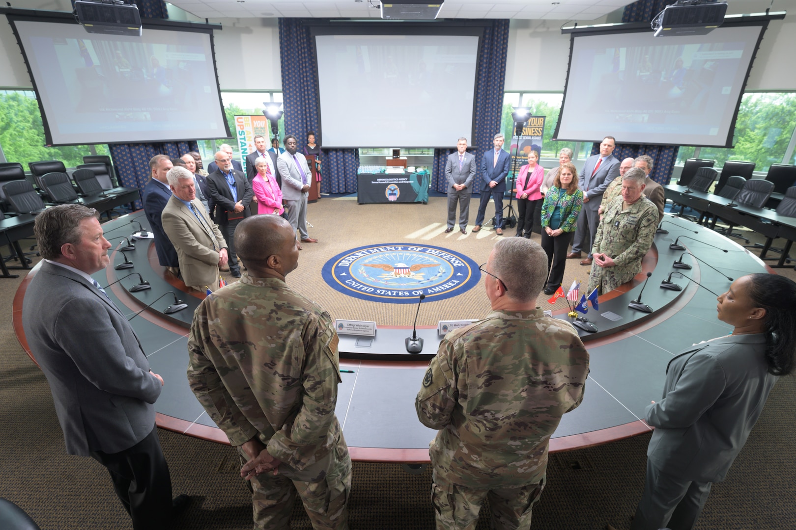 Men and women are gathered in a circle.