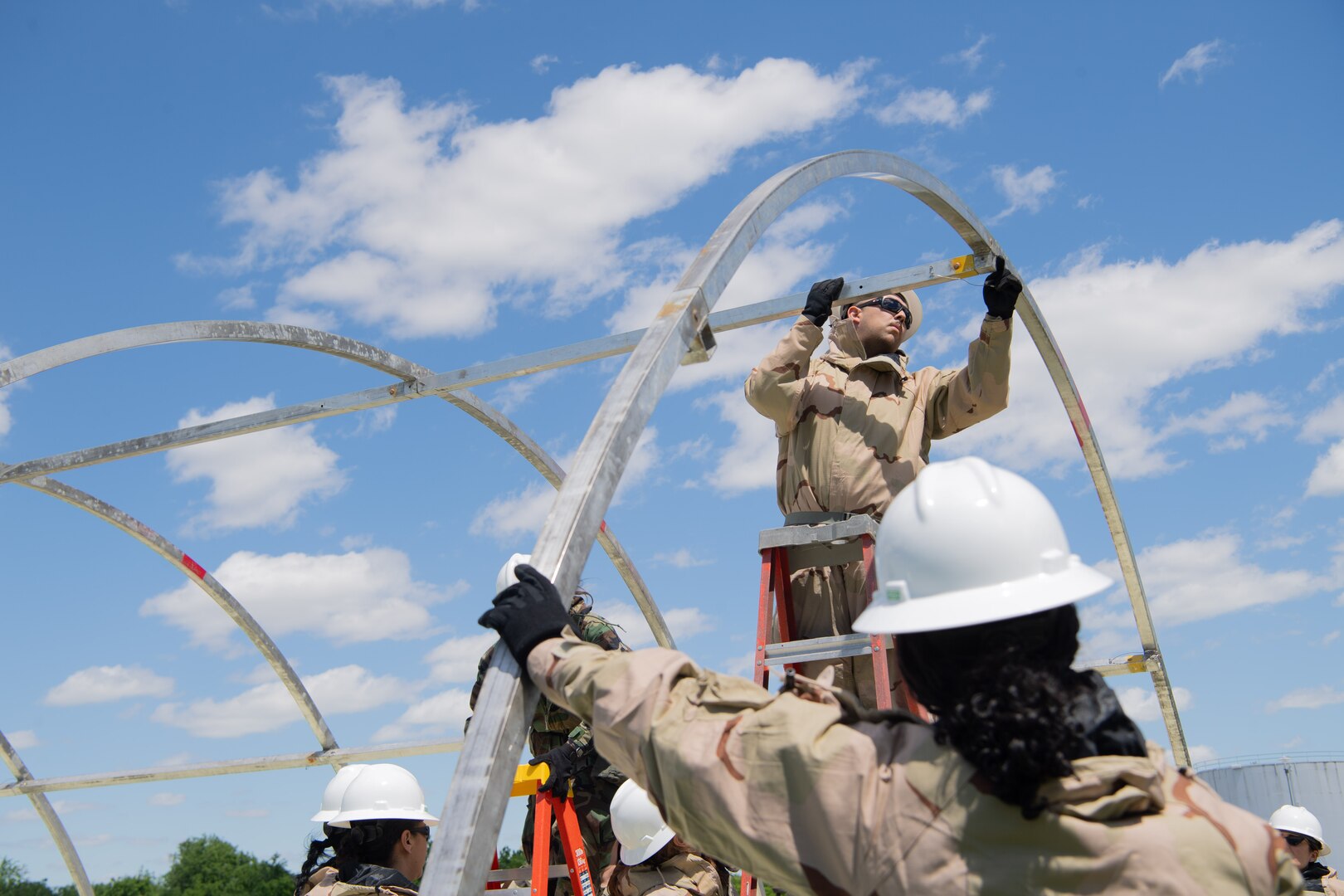 149th FW service specialist, connects the framing for a shelter tent
