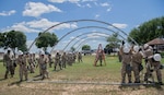 Members of the 149th Force Support Squadron build a shelter tent for training at Joint Base Lackland-San Antonio, April 10, 2024. While building the tent, the members were wearing mission oriented protective posture gear to simulate building a shelter while under a chemical, biological, radiological, and nuclear attack. (U.S. Air National Guard photo by Senior Airman Derek Gutierrez)