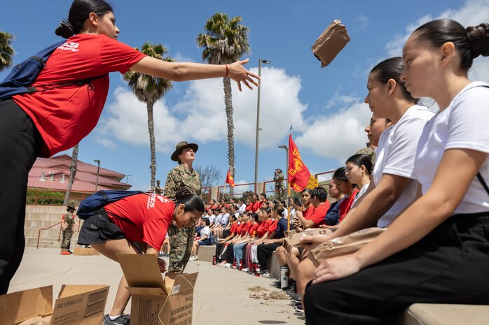 U.S. Marine Corps poolees and guests with 12th Marine Corps District receive Meals Ready-to-Eat during an all-female pool function at Marine Corps Base Camp Pendleton, Calif., April 27. The pool function consisted of poolees and guests from Recruiting Station Riverside, RS San Diego and RS Orange County. (U.S. Marine Corps photo by Cpl. Fred Garcia)