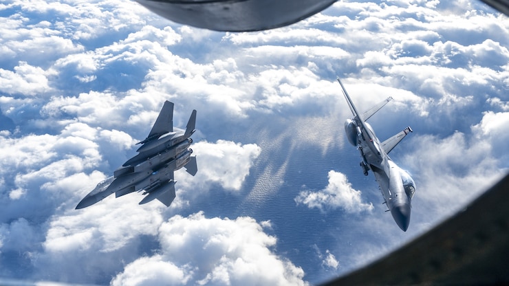 Two NORAD F-15C aircraft from the Massachusetts Air National Guard’s 104th Fighter Wing and Continental U.S. NORAD Region fly behind a KC-135 Stratotanker during air-defense Operation NOBLE DEFENDER, February 29, 2024. NORAD units executed maneuvers designed to defend the eastern approach of North America from simulated cruise missile threats in this particular operation. CF-18 aircraft from the Canadian NORAD Region, F-15C and KC-135 aircraft from the Continental U.S. NORAD Region, and B-1’s from U.S. Strategic Command all participated in the operation. NORAD conducts sustained and dispersed operations under OND to validate the missions of aerospace warning, aerospace control and maritime warning. (U.S. Air National Guard photo by Staff Sgt. Zoe M. Wockenfuss)