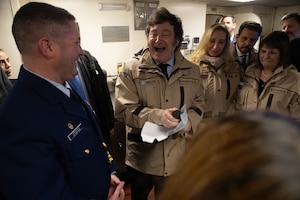 Coast Guard Capt. Donald Terkanian, commanding officer of the Coast Guard Cutter James (WMSL 754) presents a gift to the President of Argentina Javier Milei aboard the James at the Port of Buenos Aires, Argentina, April 29, 2024