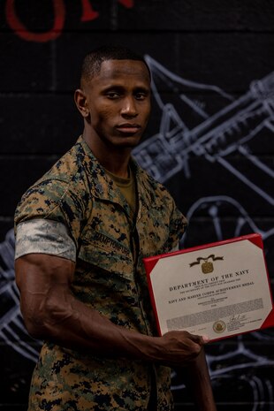 U.S. Marine Corps Sgt. David Hamptonfurr, a drill instructor with Instructions Training Company, Support Training Battalion, poses for a photo with the Navy and Marine Corps Achievement Medal at Marine Corps Recruit Depot San Diego, California, April 19, 2024. Hamptonfurr received this award due to his courageous actions by saving an individual after witnessing a car accident. (U.S. Marine Corps photo by Cpl. Joshua M. Dreher)
