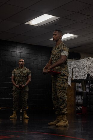 U.S. Marine Corps Sgt. David Hamptonfurr, a drill instructor with Instructions Training Company, Support Training Battalion, speaks on the importance of Marine Corps Martial Arts Program to his fellow Marines after being awarded a Navy and Marine Corps Achievement Medal at Marine Corps Recruit Depot San Diego, California, April 19, 2024. Hamptonfurr received this award due to his courageous actions by saving an individual after witnessing a car accident. (U.S. Marine Corps photo by Cpl. Joshua M. Dreher)