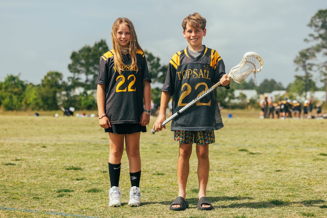 Rune Lowman, left, and Leifer Lowman, right, children of Lt. Col. Paul Lowman the executive officer of Headquarters Battalion, 2d Marine Division pose for a photo in Topsail, North Carolina, April 20, 2024. Volunteering with sports teams helps Marines engage with and contribute to the local communities by mentoring its youth. (U.S. Marine Corps photo by Cpl. Max Arellano)