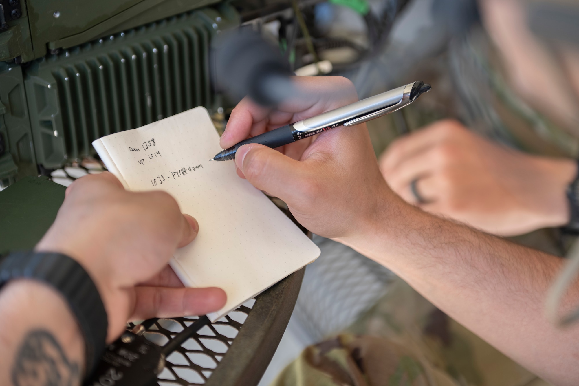 A person writing on a notebook.