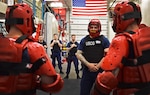 A Coast Guard member maintains officer's presence while being taunted by men dressed in "red man suits" during boarding team member training at Coast Guard Station Juneau (U.S. Coast Guard photo by Petty Officer 1st Class Jon-Paul Rios)
