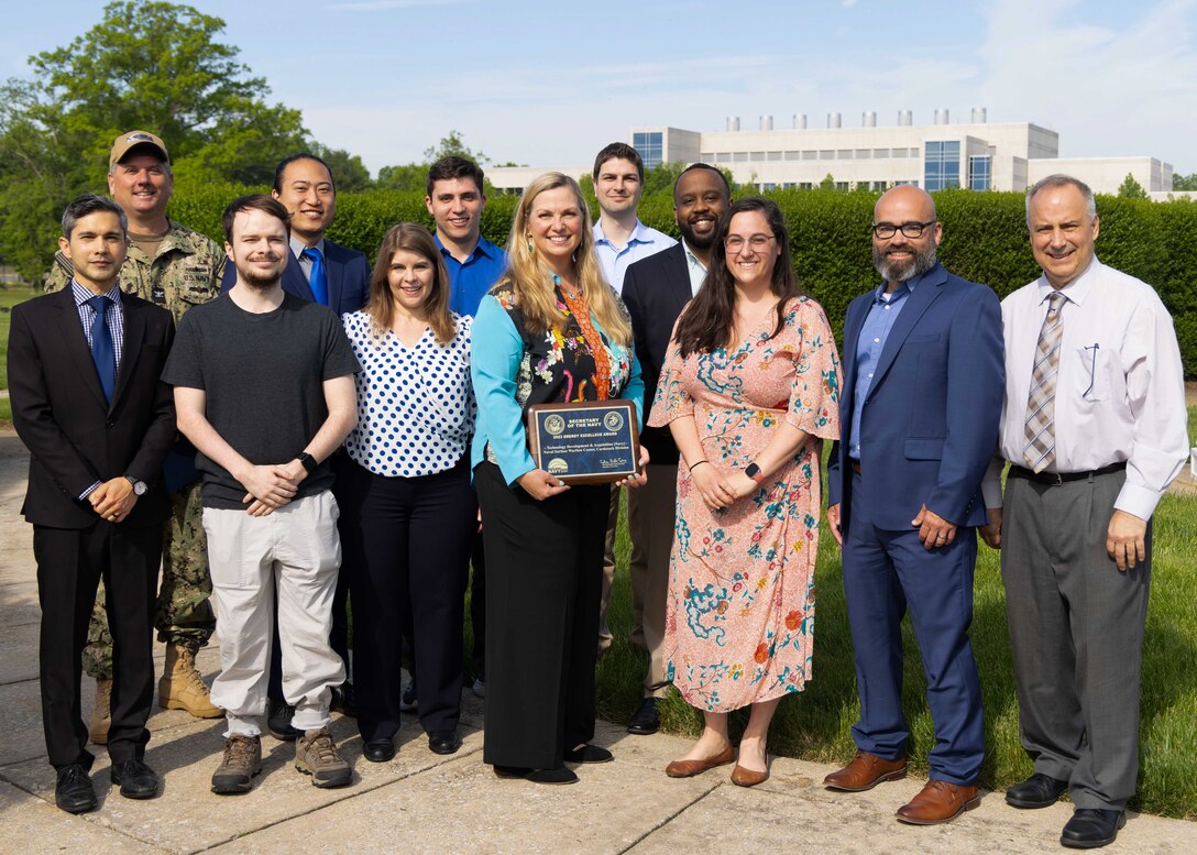 Naval Surface Warfare Center, Carderock Division Commanding Officer Capt. Matthew Tardy and Technical Director Larry Tarasek, SES, award the Lithium Battery Safety Certification Team (Code 60) with the Secretary of the Navy (SECNAV) Energy Excellence Award in West Bethesda, Md.