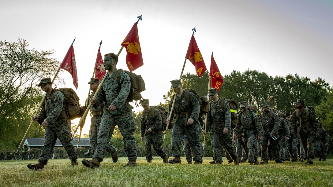 U.S. Sailors with 2d Marine Division (MARDIV) participate in a six mile hike during the Doc Kent competition on Camp Lejeune, North Carolina, April 23, 2024. This hike is held annually to commemorate Aaron A. Kent, a U.S. Navy Hospitalman, who was assigned with 2d MARDIV, II Marine Expeditionary Force and killed in action during combat in Operation Iraqi Freedom in 2005. (U.S. Marine Corps photo by Pfc. Micah Thompson)