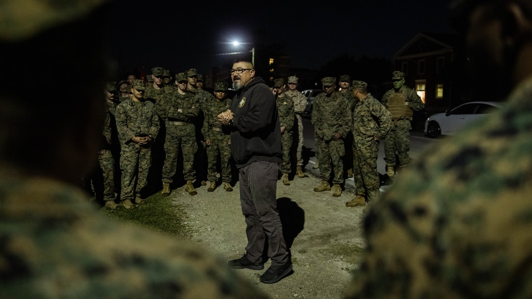 Retired U.S. Marine Corps Sgt. Maj. William Frye, a Jacksonville, North Carolina native, speaks to Sailors with 2d Marine Division (MARDIV) before a six mile hike as part of the Doc Kent competition on Camp Lejeune, North Carolina, April 23, 2024. This hike is held annually to commemorate Aaron A. Kent, a U.S. Navy Hospitalman, who was assigned with 2d MARDIV, II Marine Expeditionary Force and killed in action during combat in Operation Iraqi Freedom in 2005. (U.S. Marine Corps photo by Pfc. Micah Thompson)