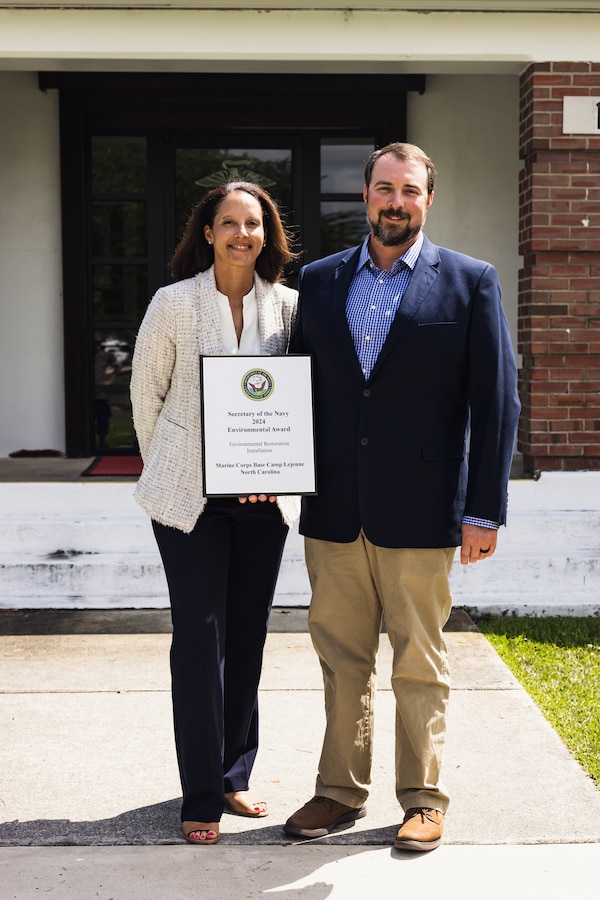 Jessica Pierson, left, underground storage tank section head, and David Towler, environmental quality branch head, both with Environmental Management Division (EMD) pose for a photo after receiving the 2024 Secretary of the Navy Environmental Award for Environmental Restoration, Installation, on Marine Corps Base Camp Lejeune, North Carolina, May 1, 2024. EMD manages an ecologically diverse installation while continuously ensuring the protection of those living, working, and training on MCB Camp Lejeune. (U.S. Marine Corps photo by Cpl. Jennifer E. Douds)