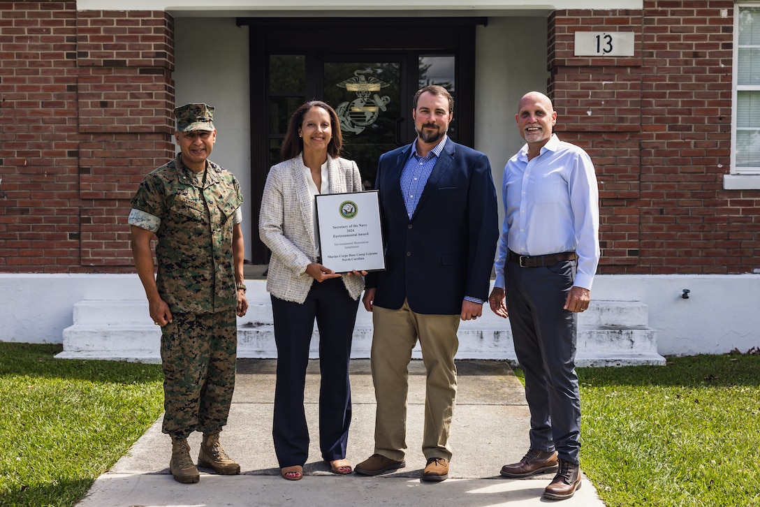 From left, U.S. Marine Corps Brig. Gen. Adolfo Garcia Jr., commanding general, Marine Corps Installations East-Marine Corps Base (MCB) Camp Lejeune, Jessica Pierson, underground storage tank section head, Environmental Management Division (EMD), David Towler,  environmental quality branch head, EMD, and Robert Lowder, director, EMD, pose for a photo after receiving the 2024 Secretary of the Navy Environmental Award for Environmental Restoration, Installation, on Marine Corps Base Camp Lejeune, North Carolina, May 1, 2024. EMD manages an ecologically diverse installation while continuously ensuring the protection of those living, working, and training on MCB Camp Lejeune. (U.S. Marine Corps photo by Cpl. Jennifer E. Douds)