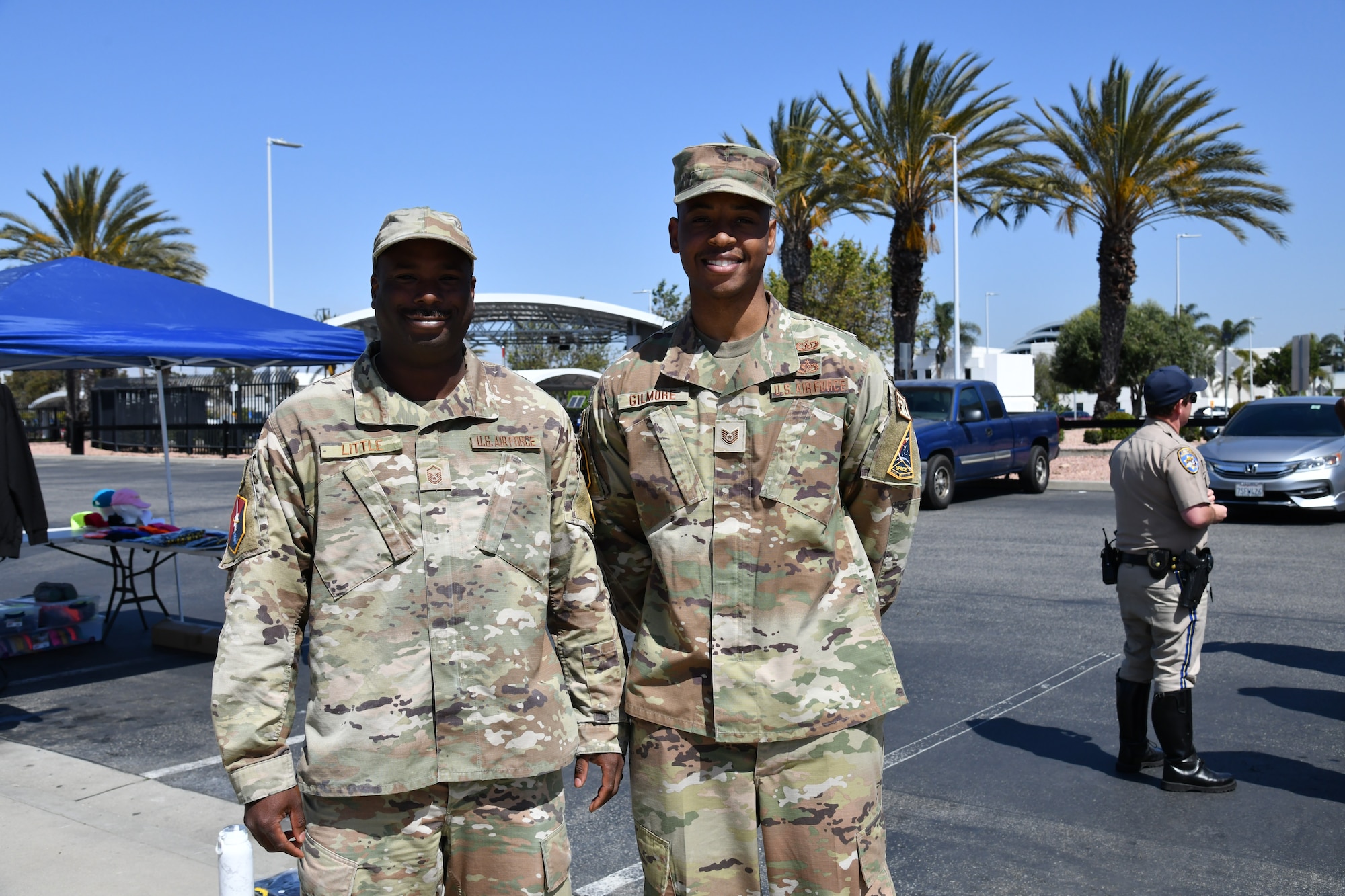 Master Sgt. Anthony Little and Tech. Sgt. Amari Gilmore, from the Space Base Delta 3 Safety Office stand together for a photo opportunity in front of the Commissary during Motorcycle Safety and Awareness Day.