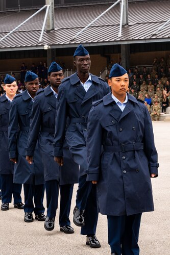 Newly naturalized U.S. citizens walk at the Pfingston Reception Center during Basic Military Training’s Coin and Retreat Ceremony, May 1, 2024, at Joint Base San Antonio-Lackland, Texas. Twenty-four Airmen were officially recognized as U.S. citizens during the ceremony. As of May 1, more than 1,000 trainees have become U.S. citizens through the Naturalization at BMT Program, which is a partnership between the 37th Training Wing and U.S. Citizenship and Immigration Services. (U.S. Air Force photo by Vanessa R. Adame)