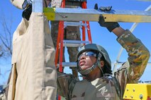 Airman installing a tent