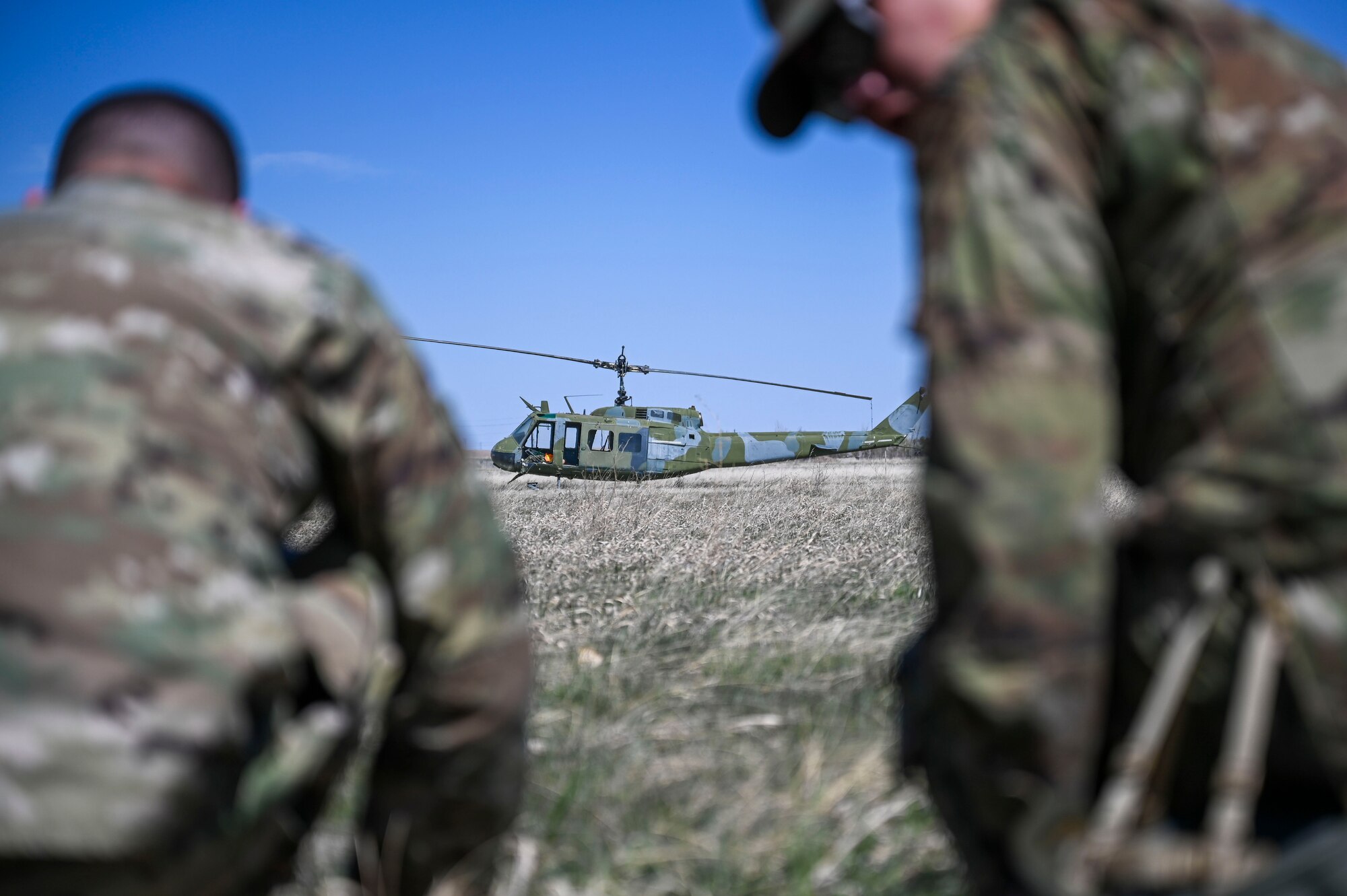 a helicopter in between two airmen