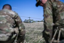 a helicopter in between two airmen