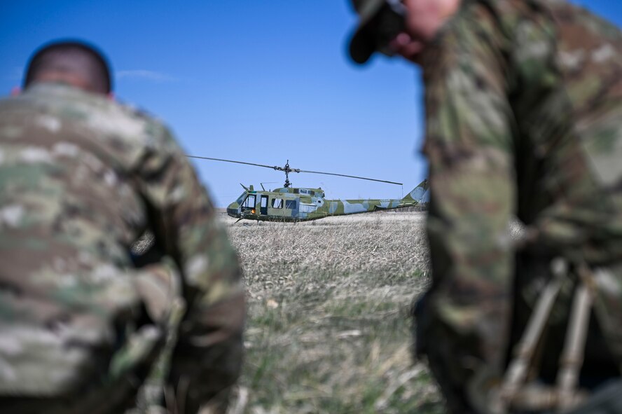 a helicopter in between two airmen