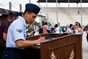 An Airman signs his U.S. Certificate of Citizenship after Basic Military Training Coin and Retreat Ceremony April 26, 2023 at Joint Base San Antonio-Lackland, Texas. The Airman was one of 14 who became U.S. citizens through the Naturalization at BMT Program.. The program, which was streamlined last year, is now online. As of May 1, 2024, more than 1,000 trainees have become U.S. citizens through the program. (U.S. Air Force photo by Vanessa R. Adame)