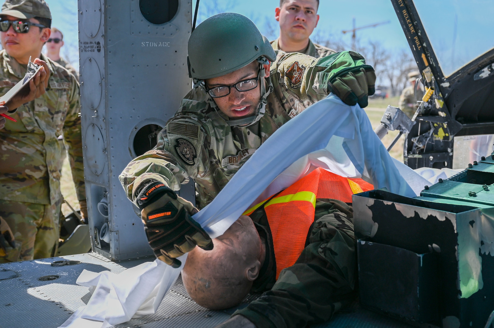 Airman lays a sheet over a mannequin