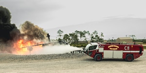U.S. Air Force Maj. Gen. David B. Lyons puts out simulated aircraft fire