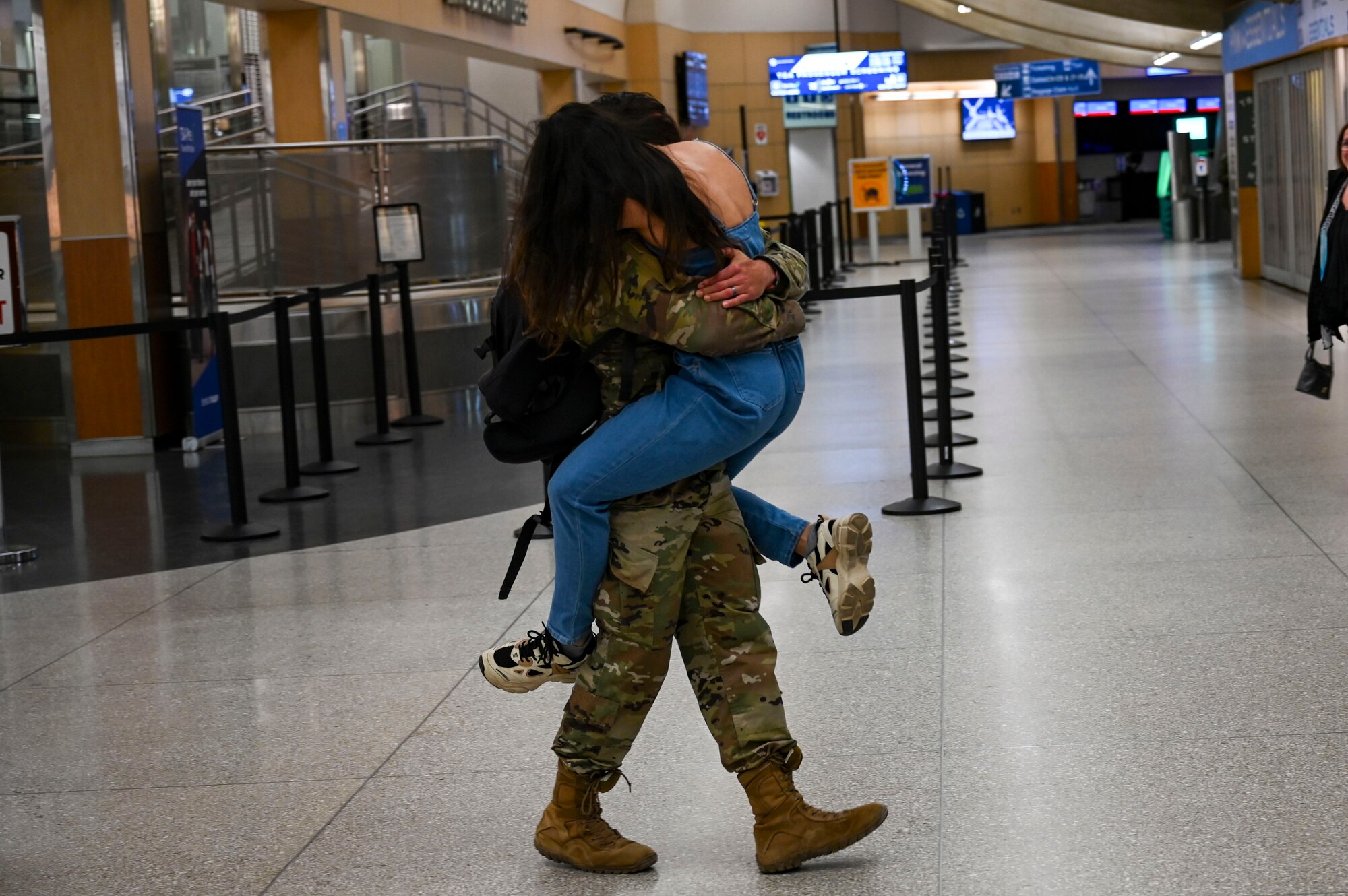 An Airman hugs his wife.