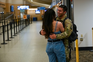 An Airman hugs his wife.