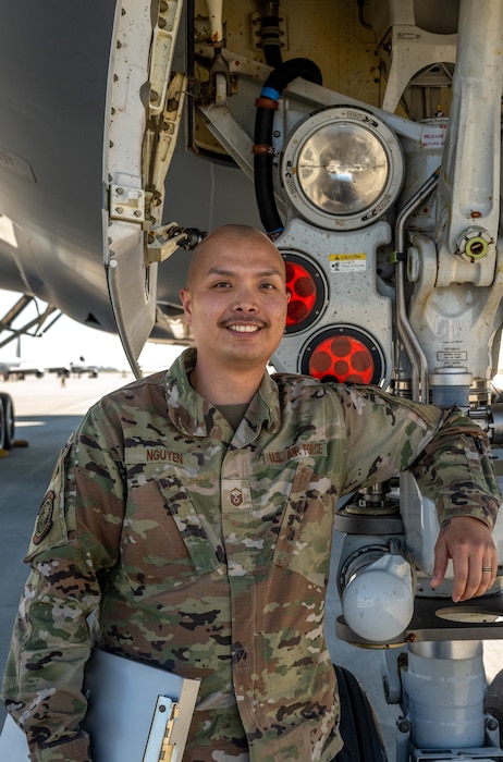 Airman stands with plane