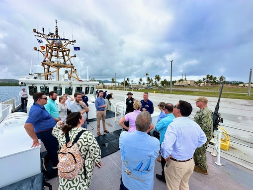 Capt. Nicholas Simmons, commander of U.S. Coast Guard Forces Micronesia/Sector Guam escorts a distinguished congressional delegation led by Congressman Sam Graves, Chairman of the House Committee on Transportation and Infrastructure and Congressman Mike Bost, Chairman of the House Committee on Veterans Affairs at the unit in Guam on April 26, 2024. The delegation, which included Congressmen David Rouzer, Troy Nehls, and Mark DeSaulnier, along with Guam Delegate James Moylan and key staff from both committees, spent the afternoon with crews, gaining firsthand insights into the critical operations of the Fast Response Cutters (FRCs) in the region. The delegation also toured critical infrastructure sites, including the damaged glass breakwater and the Port Authority of Guam, from the cutter and the cutter small boat. These sites are essential for military readiness, impact shipping routes, and influence the economic activity and cost of goods in the Marianas. (U.S. Coast Guard photo by Chief Warrant Officer Sara Muir)