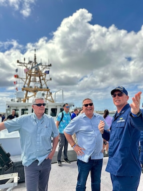 Capt. Nicholas Simmons, commander of U.S. Coast Guard Forces Micronesia/Sector Guam, discusses operations with Congressman Sam Graves, Chairman of the House Committee on Transportation and Infrastructure, and Congressman Mike Bost, Chairman of the House Committee on Veterans Affairs, from the deck of the USCGC Oliver Henry (WPC 1140) in Guam on April 26, 2024. The delegation, which included Congressmen David Rouzer, Troy Nehls, and Mark DeSaulnier, along with Guam Delegate James Moylan and key staff from both committees, spent the afternoon with crews, gaining firsthand insights into the critical operations of the Fast Response Cutters (FRCs) in the region. The delegation also toured essential infrastructure sites, including the damaged glass breakwater and the Port Authority of Guam, from the cutter and the cutter small boat. These sites are essential for military readiness, impact shipping routes, and influence the economic activity and cost of goods in the Marianas. (U.S. Coast Guard photo by Chief Warrant Officer Sara Muir)